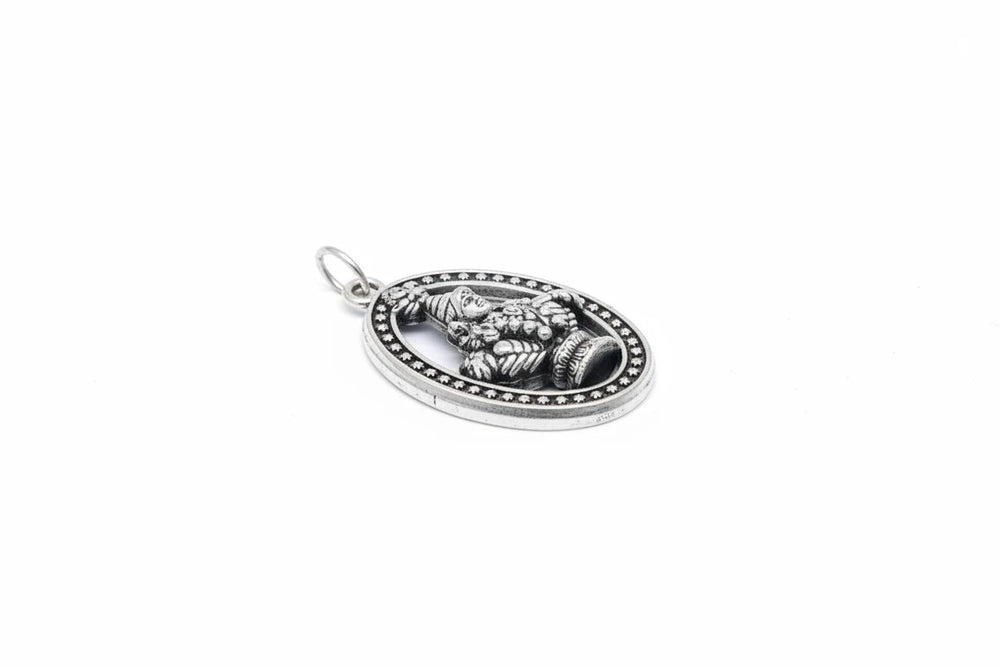 Srishti traditional oval deity pendant in oxidized silver with intricate detailing and a vintage aesthetic.